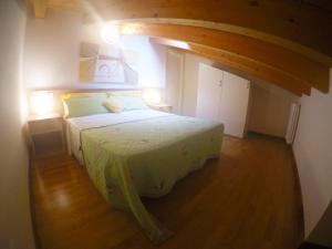 a bedroom with a large bed in a room at Residence Al Mare - Agenzia Cocal in Caorle