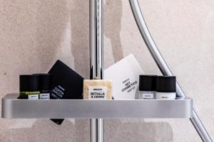 a metal shelf with some products on it at Love Suite Verona in Verona
