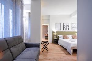 a living room with a bed and a couch at Love Suite Verona in Verona