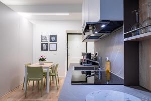 a kitchen and dining room with a table and chairs at Love Suite Verona in Verona
