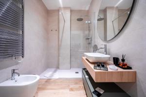 a bathroom with a sink and a toilet and a shower at Love Suite Verona in Verona +38 photos