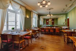 a dining room with wooden tables and chairs at Hotel Fürsteneck in Bernburg