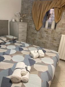 a bedroom with two beds with towels on it at A casa di Peppetto in Radicofani
