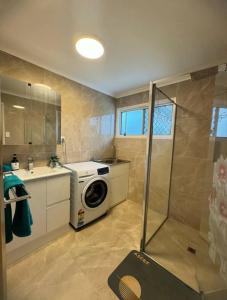 a bathroom with a washing machine and a sink at Heaven on Earth in Kingston