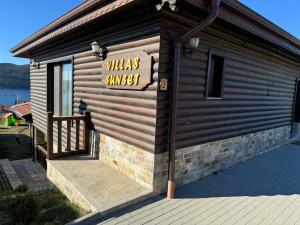 a building with a sign that reads wild smiles sunset at Вила Сънсет 2 in Dospat
