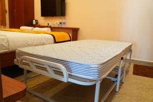 Postel nebo postele na pokoji v ubytování UJ Pallazzio - Business Class Luxury Hotel