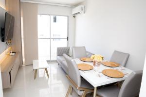 a dining room with a white table and chairs at Vista panoramica al Mar y Piscina in Cartagena de Indias