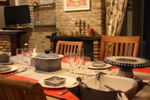 a table with plates and wine glasses on it at Maison A La Mer in Retranchement