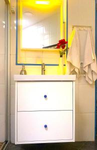 a bathroom with a white dresser and a mirror at 3 Bedroom Next to Airport & La Sagrada Familia Metro and FC barcelona Stadium in Hospitalet de Llobregat