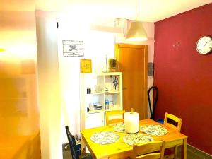 a dining room table with a candle on top of it at 3 Bedroom Next to Airport & La Sagrada Familia Metro and FC barcelona Stadium in Hospitalet de Llobregat +23 photos