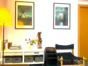 a room with a desk and a chair and pictures at 3 Bedroom Next to Airport & La Sagrada Familia Metro and FC barcelona Stadium in Hospitalet de Llobregat