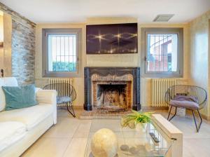 a living room with a couch and a fireplace at Villa Nirvana by Hello Homes Sitges in Sitges