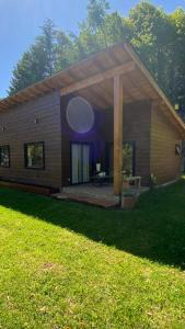 a large wooden house with a large patio at Cabaña Rústica - Sector Pichares in Pichare