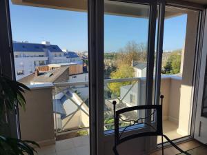 a balcony with a chair in front of a window at Grand T2 lumineux avec parking in Nantes