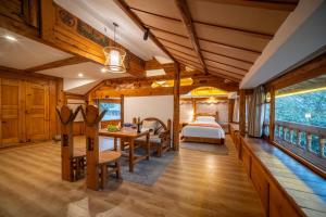 a bedroom with a bed and a table and chairs at Walk Together Hotel in Lijiang +86 photos