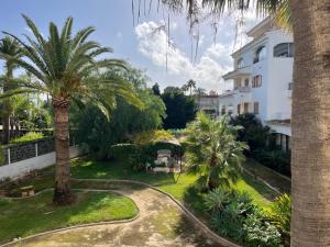 a resort with palm trees and a building at Wind Rose Study Xàbia in Jávea
