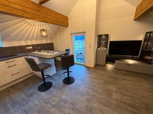 Sjónvarps- og/eða afþreyingartæki á Ferienwohnung Unsere Mühle