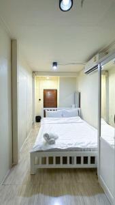 a bedroom with a large white bed in it at Chubbi5 room11 in Bangkok