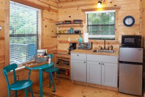 a kitchen with a sink and a table and chairs at Arbor House of Dripping Springs - Nautical House in Dripping Springs