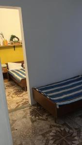 Postel nebo postele na pokoji v ubytování Olympia Ureki Guria Street 24-26