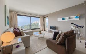 a living room with a couch and a large window at Samara 20 Luxury Apartments Spa Gym Pools Panoramic Views in Marbella