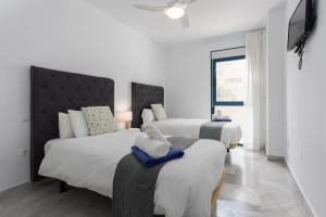a bedroom with two beds with towels on them at 3D MTR - Marbella Temporary Rent Two Bedrooms Apartment Marbella Old Town in Marbella