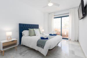 a bedroom with a large bed and a large window at 3D MTR - Marbella Temporary Rent Two Bedrooms Apartment Marbella Old Town in Marbella +19 photos