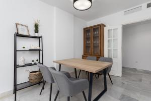a dining room with a wooden table and chairs at 3D MTR - Marbella Temporary Rent Two Bedrooms Apartment Marbella Old Town in Marbella