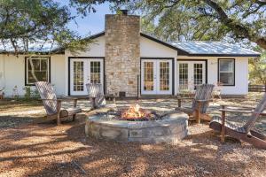 a fire pit in front of a house at Red Donkey Cottage in Wimberley