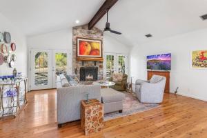 a living room with a couch and a fireplace at Red Donkey Cottage in Wimberley