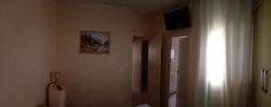 a room with a hallway with a picture on the wall at Cantinho do Sossego in Valinhos
