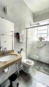 a bathroom with a toilet and a sink and a shower at Casa Diamantina in Diamantina +49 photos