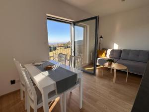 a living room with a table and a couch at Apartmány Na Pavlači in Benecko