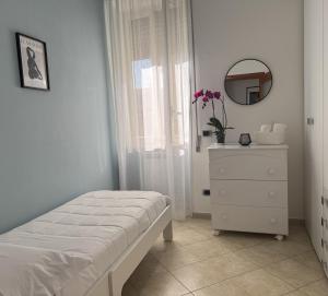 a bedroom with a bed and a dresser and a mirror at Villa Titina in Naples