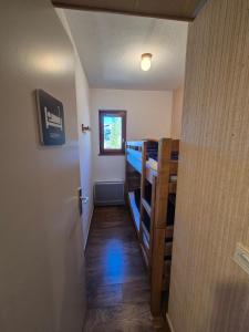 einen Flur mit einem Zimmer mit Etagenbetten und einer Tür in der Unterkunft Appartement 4 personnes au pied des pistes in Les Déserts