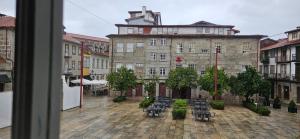 a view of a courtyard with chairs and a building at Retiro Studio 34 in Guimarães