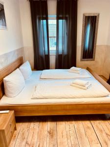 a bedroom with a bed with two towels on it at Gästehaus Dolce Vita in Rust