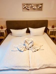 a bed with a heart made out of towels at Gästehaus Dolce Vita in Rust +53 photos