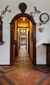 an open hallway with a clock on the wall at Greenheart Boutique Hotel in Paramaribo +105 photos