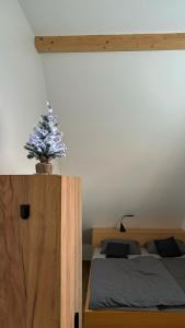 a bedroom with a bed with a christmas tree on it at Bella Apartment in Žirovnica