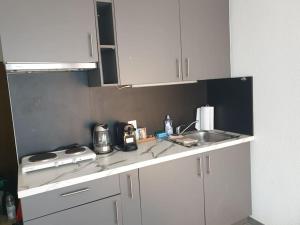 a kitchen with white cabinets and a sink at El Silencio Apartments in Zurich +13 photos