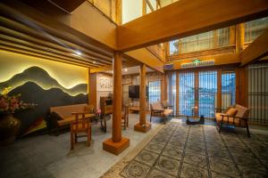 a lobby with a mural of mountains on the wall at Walk Together Hotel in Lijiang