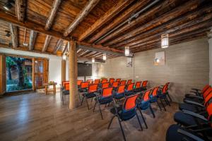 an empty lecture room with orange chairs in it at Walk Together Hotel in Lijiang
