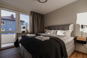 a bedroom with a large bed with towels on it at Huskvarna Apartments in Huskvarna