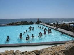 a group of people in a pool of blue water at Apartamento Newark in Matosinhos