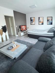 a living room with a couch and a bed at Gemütliches Apartment vor den Toren Kölns in Hürth