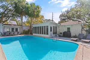 a swimming pool in front of a house at Soulful of Sunshine - 4314 Eleventh Street in Saint Simons Island