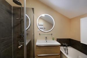 a bathroom with a sink and a mirror at La ferme d aumontzey in Aumontzey +27 photos