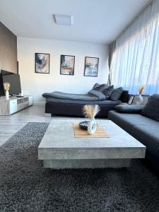 a living room with a couch and a table at Gemütliches Apartment vor den Toren Kölns in Hürth