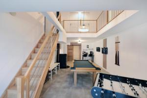 a room with a pool table and a staircase at La ferme d aumontzey in Aumontzey